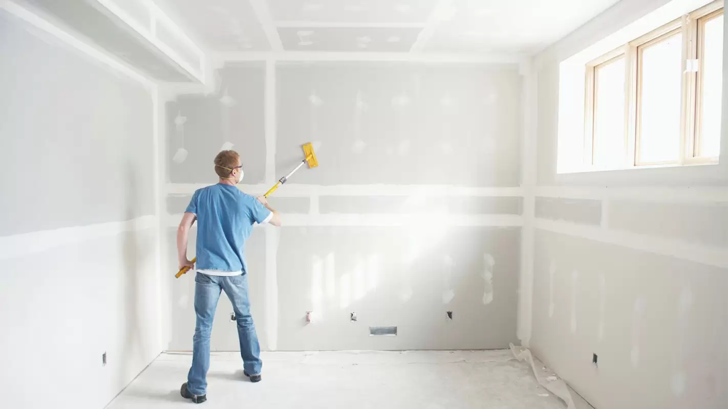 Priming a freshly finished drywall wall and ceiling