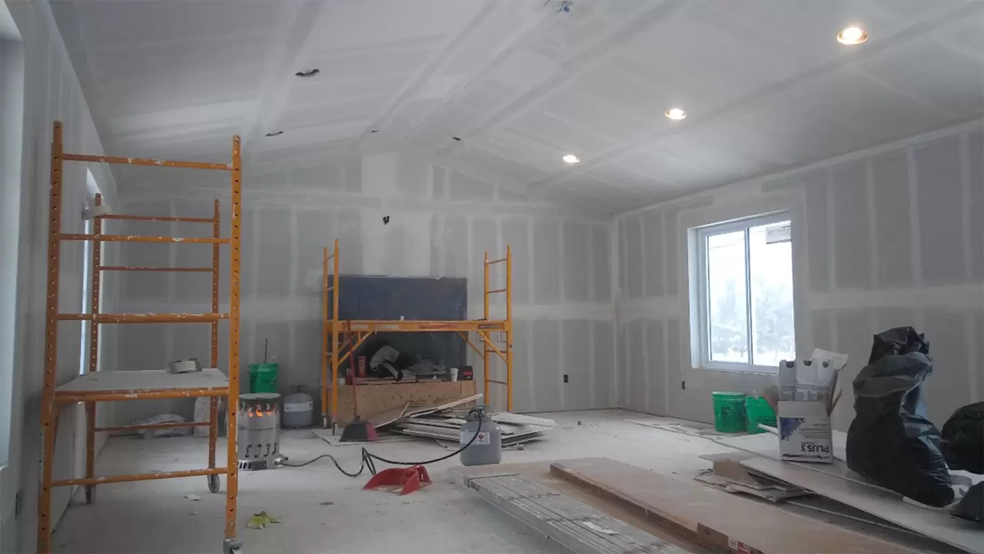 New drywall installed and taped throughout a framed room